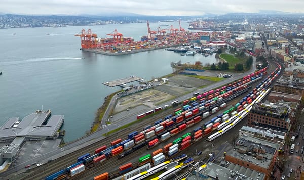 train cars are stacked with containers at vancouver b.c.'s waterfront harbor.