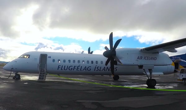 a small passenger plane with propellers readies to take off.