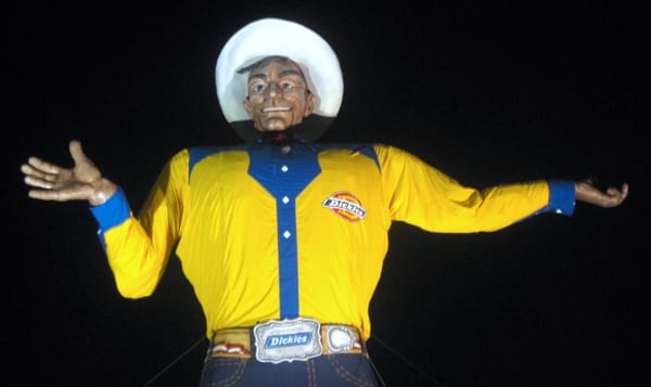 a picture of Big Tex at night. Big Tex, the giant statue of a white guy in hideous clothing, used to welcome visitors to the 