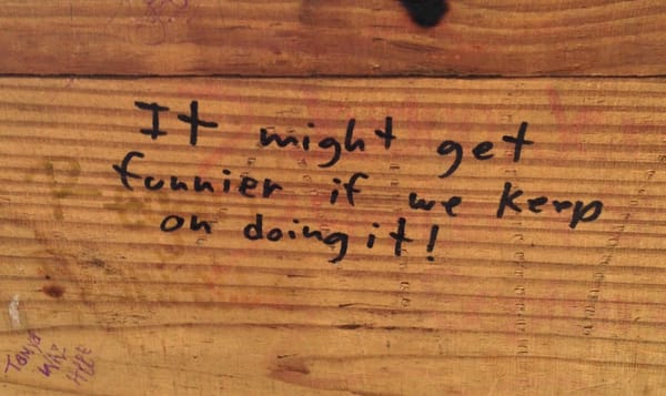 handwritten graffiti in Sharpie on a piece of wood