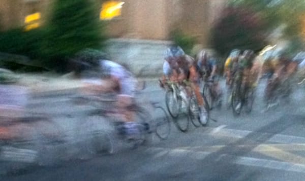 cyclists riding in a pack on the street