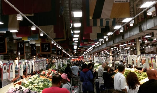 customers shopping for produce in a large store