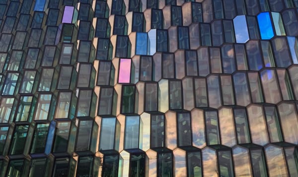 a closeup photo of Harpa, a performing arts center in Reykjavic with a honeycomb-like window design