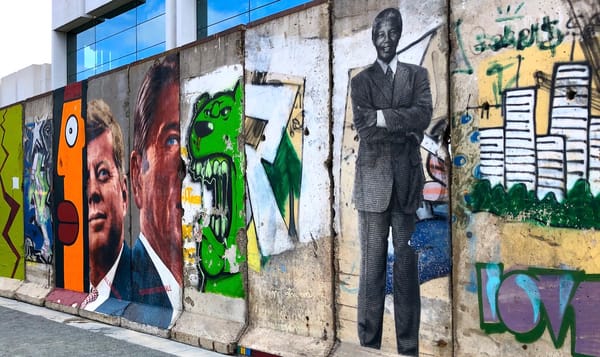 a section of the torn-down berlin wall covered in graffiti