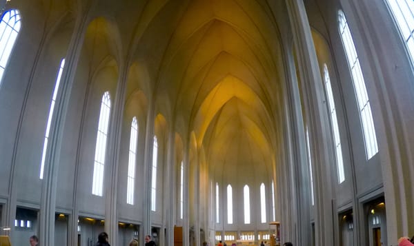 the interior of a cathedral with high ceilings that curve to a central point