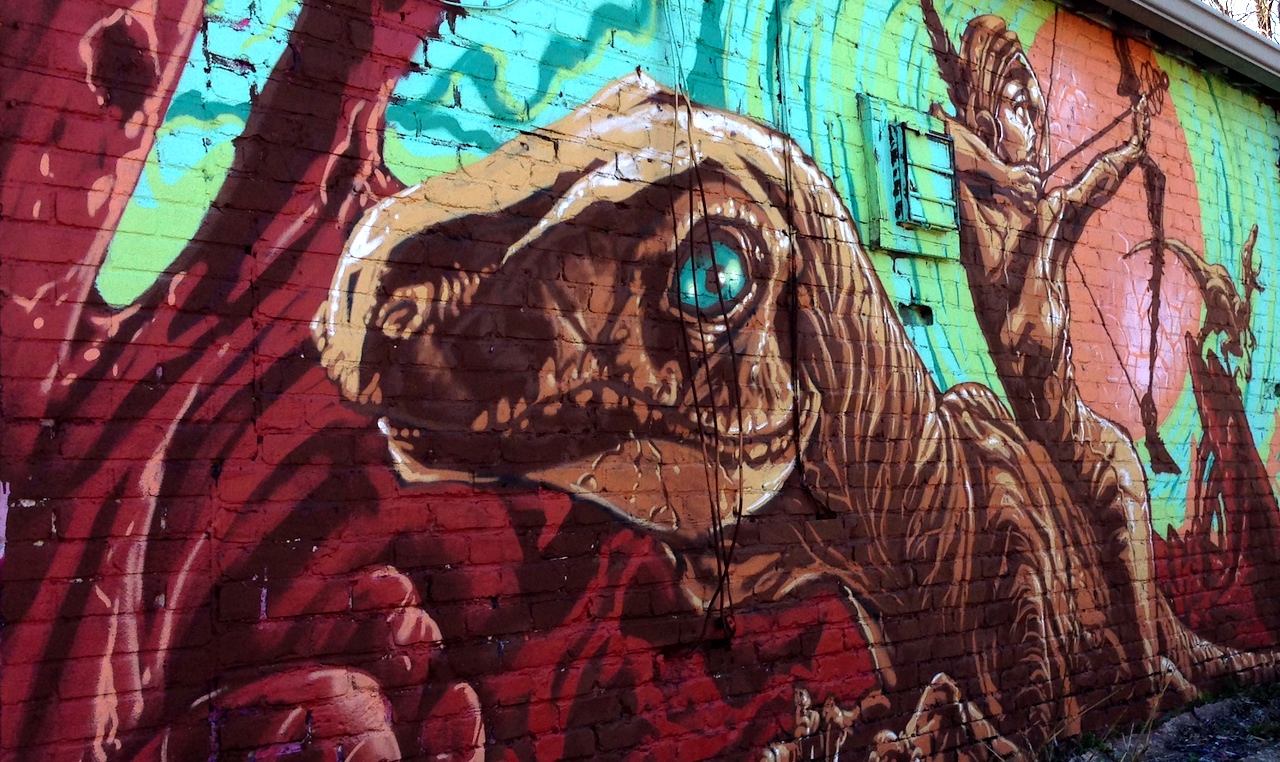 a mural of an archer riding a dinosaur