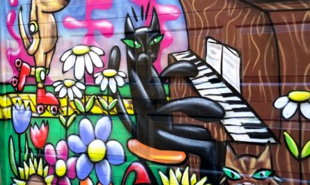 a spray paint mural of a few animals doing fun stuff in a field of flowers