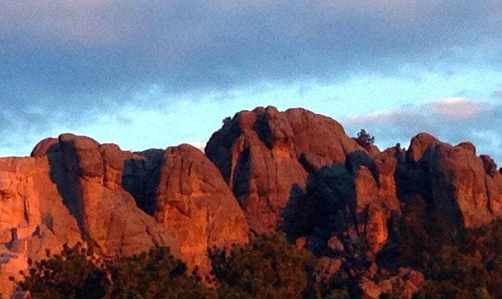 a sunrise photo of the tail end of the six grandfathers mountain in present-day South Dakota