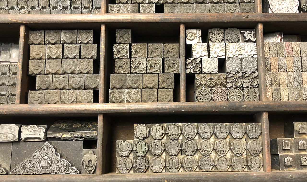 a drawer full of metal letters from a printing press