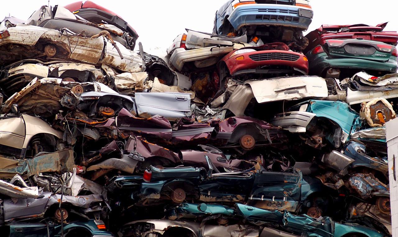 a pile of cars in a junkyard