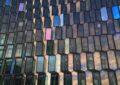a closeup photo of Harpa, a performing arts center in Reykjavic with a honeycomb-like window design