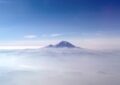 view from a plane of mount rainier above the clouds