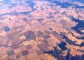 squares of farmland in central idaho as seen from a plane