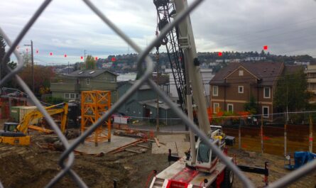 view of a construction site through a chain link fence