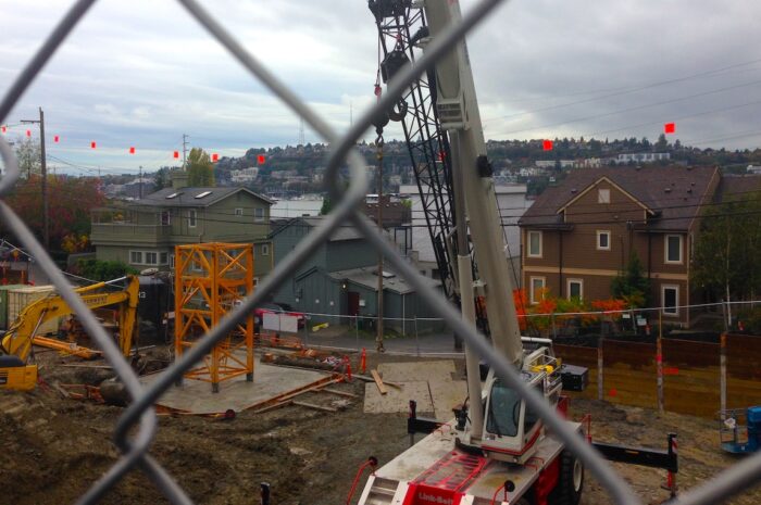 view of a construction site through a chain link fence
