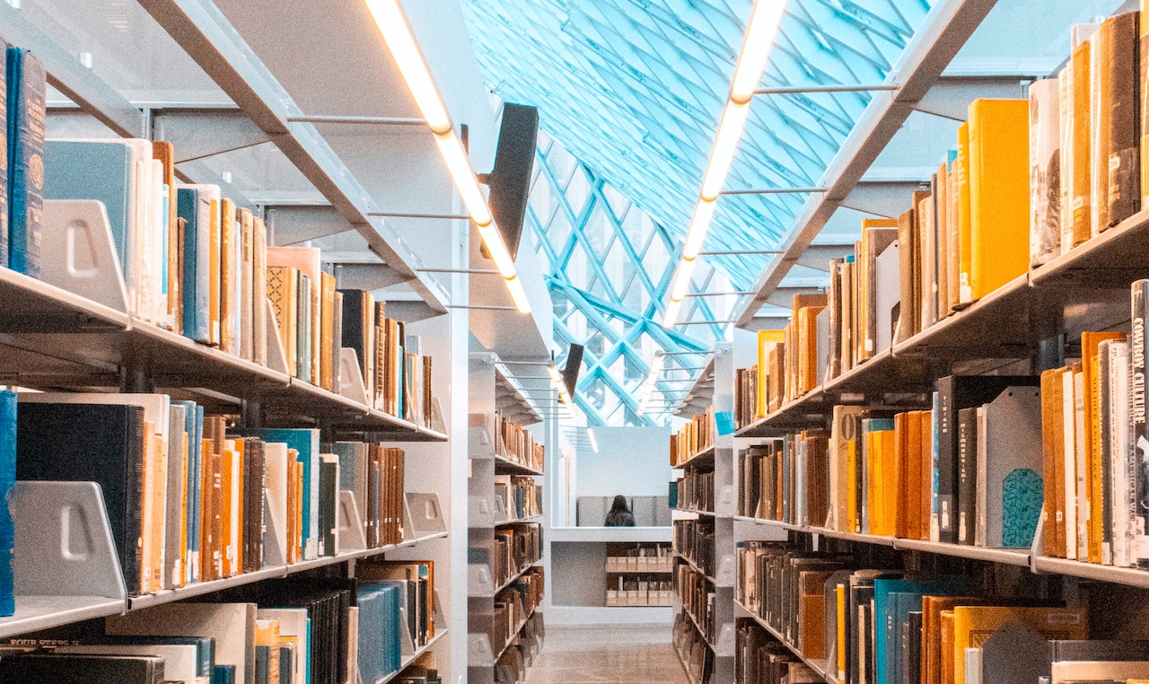 an aisle between two shelves of books at the seattle public library