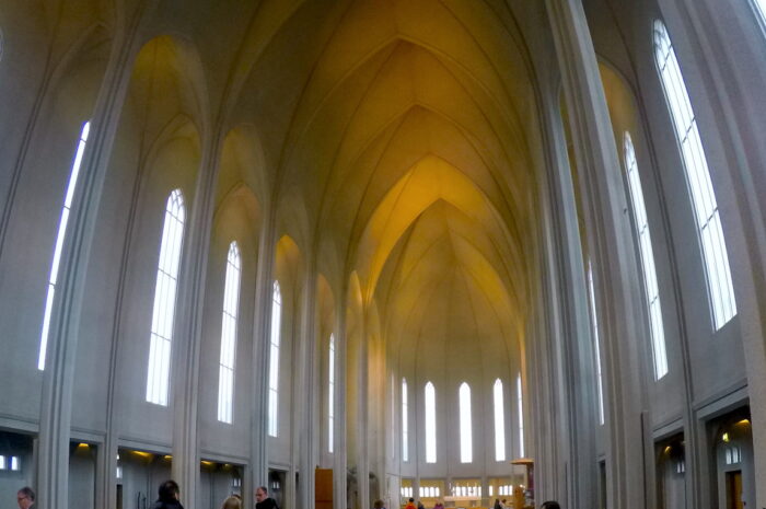 the interior of a cathedral with high ceilings that curve to a central point