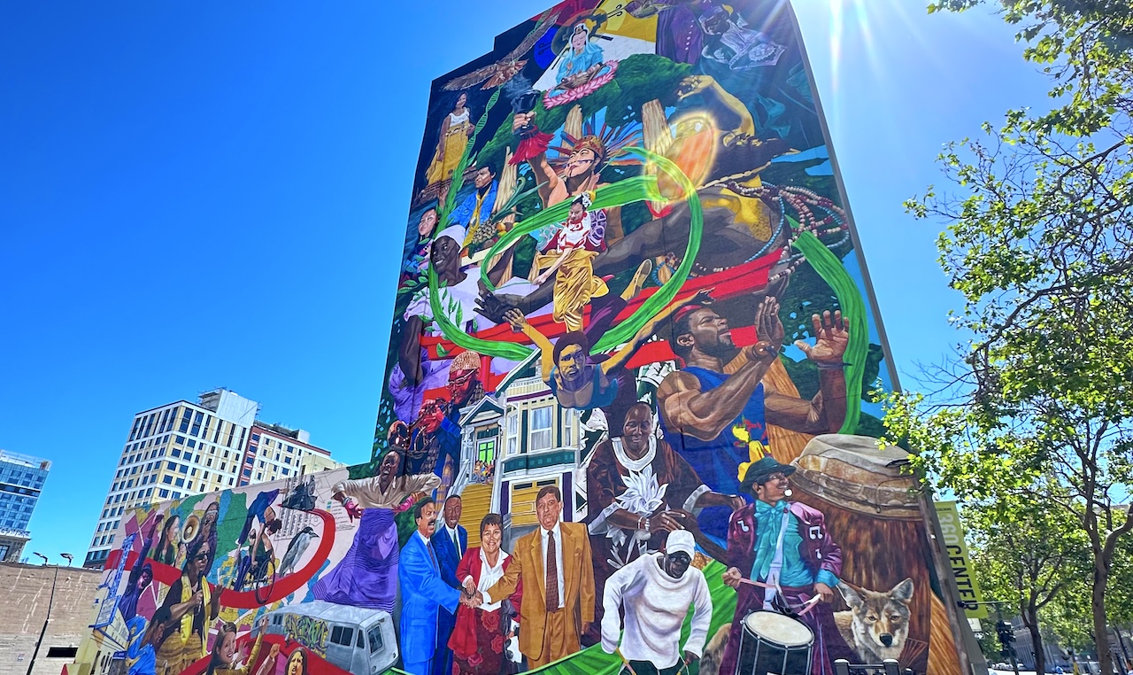 a mural in oakland, california containing dozens of cultural figures and places.