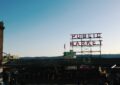 a daytime photo of the pike place market sign with a filter on it