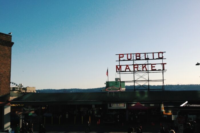 a daytime photo of the pike place market sign with a filter on it